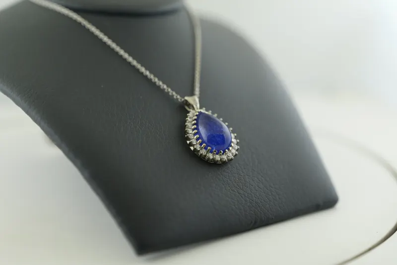 Close raw product photograph of the pendant on a black display